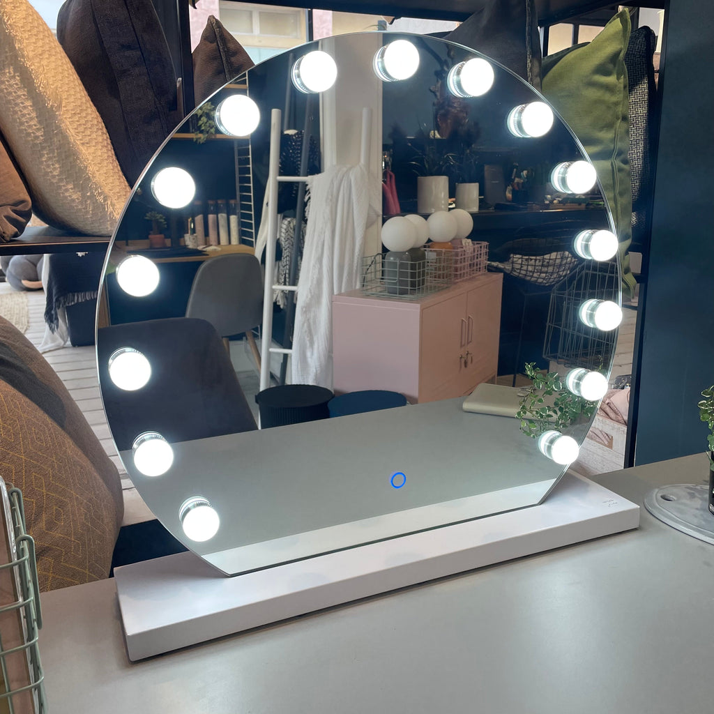 mirror with light-bulbs on table